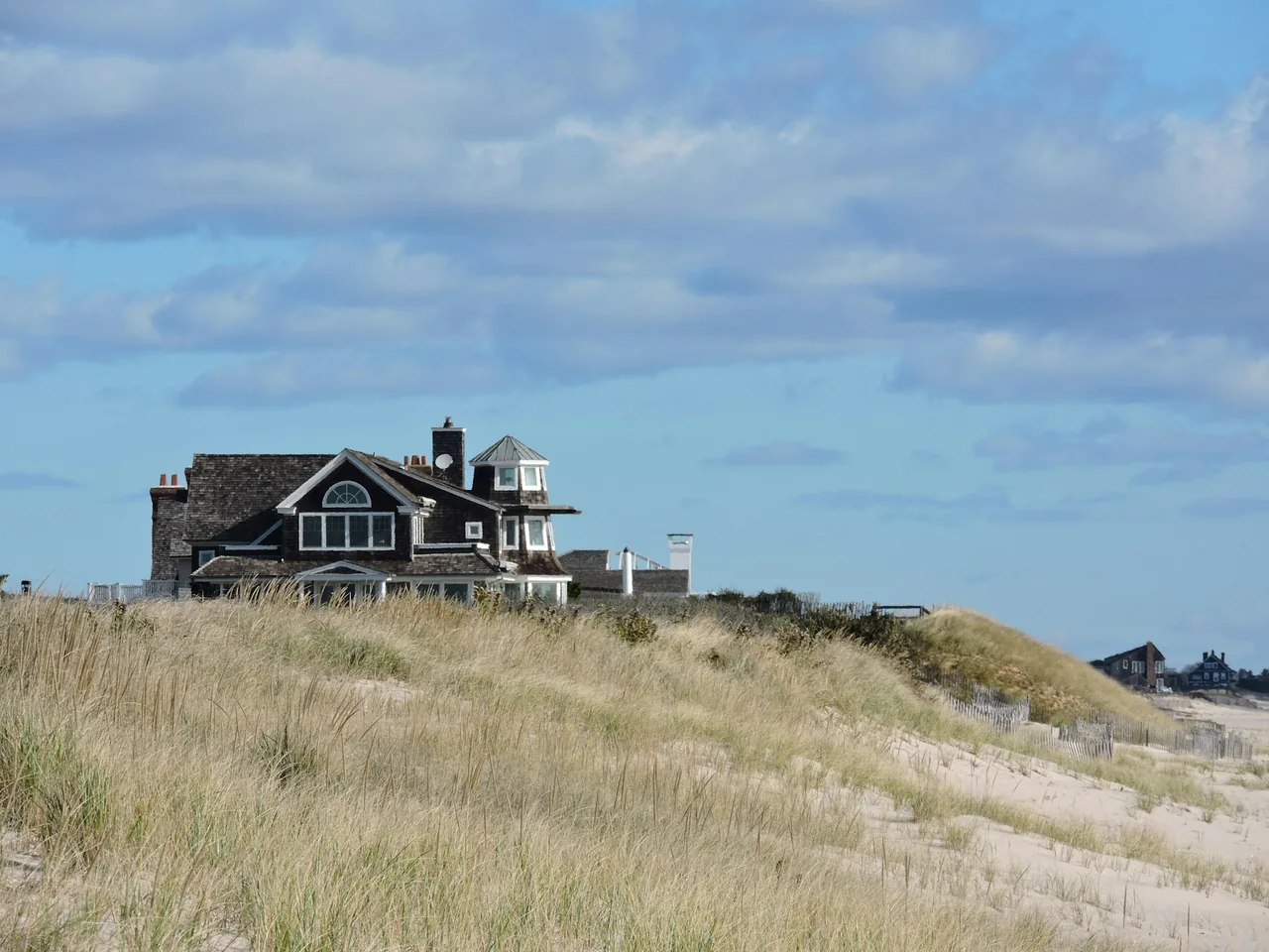 Shingled coastal home above beach dunes in the Hamptons, New York